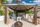Riverside canopy with fire pit, Adirondack chairs, and tiki bar