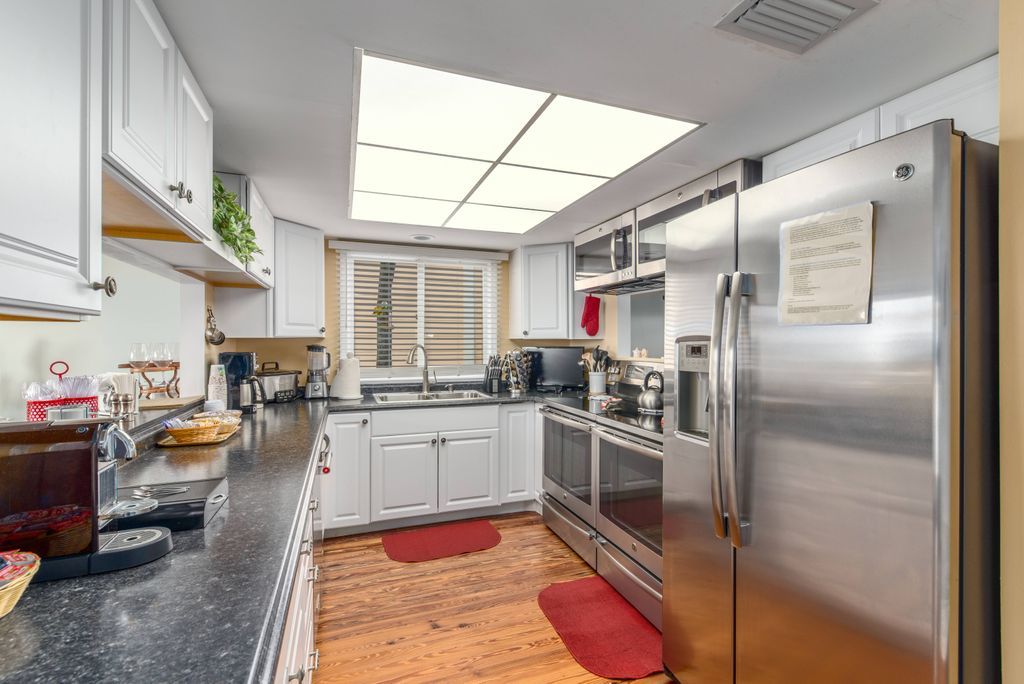 Galley style kitchen with stainless steel appliances