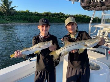 Two boys on a chartered boat showing fish caught in Stuart Florida